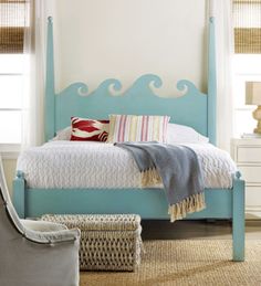 a bedroom with a blue bed and white furniture