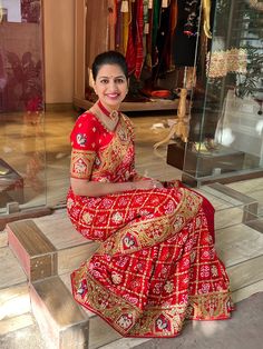 Handmade Exclusive Gharchola Saree in Red colour. The Gharchola bandhani saree is in pure Gajji silk with the beautiful gota patti, zardozi and resham border made throughout on the saree. The saree has beautiful floral motifs all over. The blouse is stylish with border design on sleeves. The saree has a lovely combination of elephant and peacock with floral design. It gives appearance of a royal garden. The work is all handmade in golden coloured gota patti, zardozi and colourful resham. Length of the saree is 5.5 meters. The saree is handmade by us at Rana's by Kshitija. For colour customisation contact us at: kshitija@ranaonline.com or 7023953082. Product Highlights for Handmade Exclusive Gharchola Saree in Red: Fabric: Pure Gajji Silk Embroidery: Gota patti, Zardozi and Resham Colour: R Bandhej Blouse Designs Latest, Gharchola Saree, Marriage Clothes, Fashionable Saree, Bandhej Saree, New Saree Blouse Designs, Lehenga Designs Simple, Wedding Lehenga Designs, Designer Bridal Lehenga