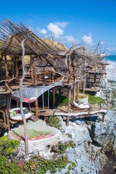 the beach is lined with thatched huts and hammocks