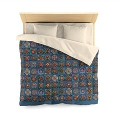 an image of a bed with blue and red bedspread set on it's side