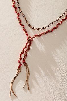 Forever cool and classic, this totally timeless necklace is featured in a layered, bolo-inspired silhouette with metal, textile, and beading throughout for a colorful, dimensional finishing touch. | Ring Of Fire Bolo Necklace by Free People in Gold Red Statement Necklace, Bohemian Red Necklaces, Bohemian Long Red Necklace, Free People Rings, Unique Red Multi-strand Beaded Necklace, Red Multi-strand Bohemian Necklace, Bolo Necklace, Red Gold, Free People