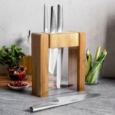 a cutting board with knifes and other kitchen utensils on top of it