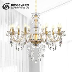 a chandelier hanging from the ceiling in a room with white walls and curtains