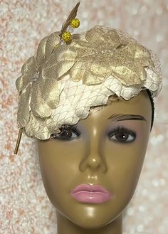 Gold and Cream Flower Fascinator Half Hat, Weddings, Church, Tea Parties, and Other Special Occasions  Accented with veil netting, feather, hat pin, and iridescent flower. The hat pin may vary and is for decorative purposes only. The hat is affixed to the head via a hatstring. Available in 2 sizes: 8 X 5.5 inches  10 X 7 inches The mannequin is wearing the 8 by 5.5 inches. Handmade Gifts for mom, sister, wife, or yourself. SHIPPING  All items for free shipping will be shipped via USPS FIRST CLAS Luxury Cream Hat Headpiece, Gold Costume Hats For Spring Wedding, Gold Costume Hats And Headpieces For Spring Wedding, Wedding Costume Hats And Headpieces With Handmade Flowers, Kentucky Derby Headband Mini Hat For Ceremony, Kentucky Derby Mini Hat Headband For Ceremony, Elegant Wedding Hats And Headpieces With Handmade Flowers, Adjustable Hat For Ceremony, Elegant Adjustable Hair Accessories For Ceremony