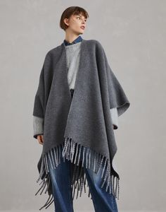 Wool and cashmere double knit poncho This double knit poncho conveys the perfect balance between cozy comfort and timeless style. The refined double knit is crafted with two layers of fabric bonded together to create a garment with a compact texture that is extraordinarily soft to wear. The unconstructed wide, fluid silhouette drapes over the body and will follow every move with an elegant naturalness. How To Wear A Blanket Scarf, Tuxedo T Shirt, Athleisure Looks, Barbie Sewing, Knit Poncho, Cashmere Fabric, City Outfits, Knitted Poncho, Double Knit