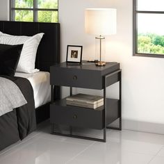 a black and white bedroom with a bed, night stand, nightstand and window in the background