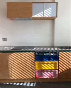 an empty kitchen with wooden cabinets and drawers