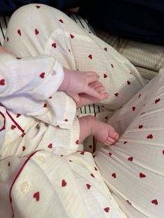 a baby laying on top of a bed wearing pajamas