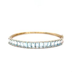 Emerald Cut Aquamarine Bangle Bracelet in 14k Yellow Gold This modern bangle bracelet is crafted in 14 karat yellow gold. Featuring emerald-cut aquamarines, this bracelet is a show-stopper. The vibrant aquamarine stones weigh 6.97 carats and run across the top half of the bracelet. This gorgeous bracelet is a perfect accessory for any special occasion and is sure to be cherished for years to come. PRIMARY STONE Stone: Aquamarine Shape: Emerald Weight: 6.97 ct Measurements: 5.92 mm x 3.97 mm x 2. Modern Bangle, Aquamarine Bracelet, Wedding Jewelry Bracelets, Aquamarine Stone, Aqua Marine, Gold Filigree, Gorgeous Bracelet, Shop Engagement Rings, Wedding Bracelet