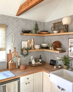 a kitchen with open shelving and wooden counter tops on the wall above the sink