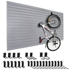 a bike hanging on the side of a garage door with several hooks and bars attached to it