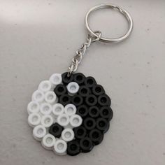 a black and white keychain with circles on it