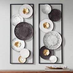 two large metal wall art pieces hanging on the wall