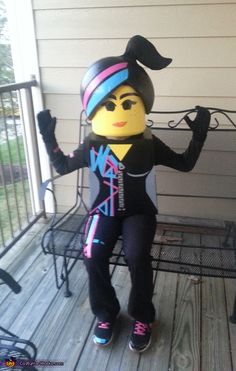 a person in a costume sitting on a porch with their arms up and legs crossed