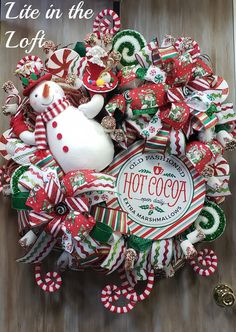 a christmas wreath with a snowman and candy canes on it that says, life in the hot cocoa