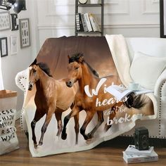 two horses running in the wind on a blanket