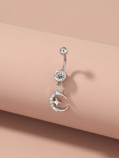 a pair of dangling belly rings with crystal stones on the end, and a crescent