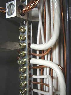 the inside of an electrical panel with many wires