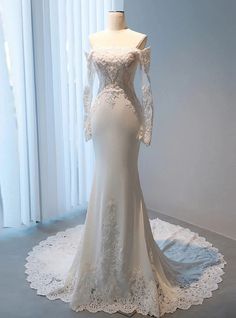 a wedding dress on display in front of a window