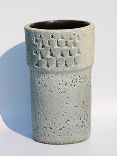 a ceramic cup with writing on the outside