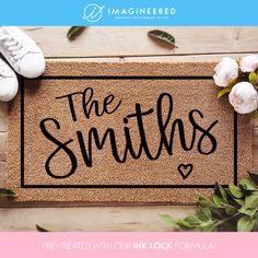 a door mat with the words, the smiths on it next to shoes and flowers