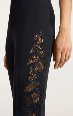 Experience the perfect balance of style and comfort with our Cutout Paisley Embellished Kerry Pant. Made from Drapey Crepe fabric, these straight leg trousers feature an eye-catching Cutout Paisley detail along the side of the leg. Elevate your look and add a touch of unique flair to any outfit with these statement pants! Details Zipper fly and button closureFabric: Drapey CrepeStraight legCut Out Paisley detailsFull length Content and Care 69% Triacetate 31% PolyesterDry Clean OnlyImported Meas Embellishments On Fabric, Statement Pants, Skirt Coverup, Fabric Embellishment, Fashion Sketches Dresses, Couture Sewing Techniques, Sketches Dresses, Fashion Tops Blouse, Pants Details