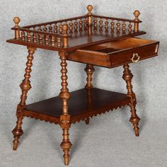 an antique wooden table with drawers on it