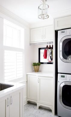 a washer and dryer in a white laundry room