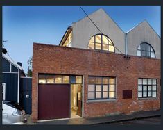 an old brick building with two large windows