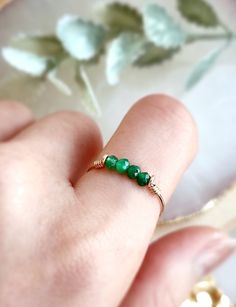 Dainty & Petite Raw Green Jade Bar Ring ✨Handmade 14K Gold Filled, Rose Gold Filled, Sterling Silver, Dainty Crystal Ring 💚 Simple design stacking ring with Jade stone beads (not natural color). Very dainty and cute ring for everyday wear. *Gemstone Size: 2-3 mm *Ring Band:  0.8 mm  ✨ Jade Gemstone Meaning ✨ * Jade is a symbol of good fortune, abundance, wellness & harmony. It is a precious charm used to bring positive energy to the wearer.  * Handmade in your ring size natural gemstones and 14 Sterling Silver Crystal Ring, Green Jade Ring, Beads Ideas, Green Stone Rings, Gemstone Meanings, Bar Ring, How To Make Rings, Homemade Jewelry, Jade Ring