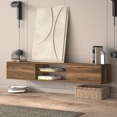 a wooden shelf with books and magazines on it in front of a wall mounted art piece