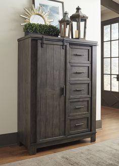 an armoire with many drawers on top of it