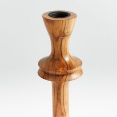 a wooden vase sitting on top of a white table