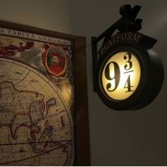 a clock mounted to the side of a wall with a map on it's face