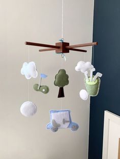 a crib mobile with baby's toys hanging from the ceiling in a nursery