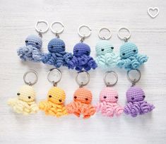 small crocheted octopus keychains in different colors on a white table top