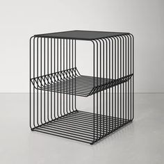 a black metal shelf with two shelves on each side