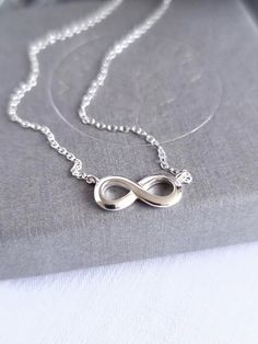 This stunning infinity necklace is made of 925 Sterling Silver, complete with an 11-5mm Infinity Charm.  The cable chain measures 44cm in length, and has an extra 2cm extension. It is minimalist yet elegant, and is designed to be worn day or night, making the perfect birthday of Christmas gift for someone you love. All MysticSilver jewellery is 925 Sterling Silver, Hypoallergenic, and is Nickel and Lead free. PACKAGING Your order will be carefully wrapped in specially formulated tissue paper, which is designed to ensure your jewellery stays tarnish free, and then placed in a pretty organza bag. Or you can choose to upgrade to one of our beautiful MysticSilver gift boxes, which make the perfect packaging for presents. DELIVERY Your order will be posted usually within 1-2 working days by Roy Infinity Jewellery, Pretty Valentines, Infinity Necklace Silver, Birthday Presents For Friends, The Summer I Turned Pretty, Infinity Charm, Infinity Jewelry, Pendant Choker, Silver Chain Style