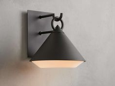 a black wall light mounted on the side of a gray wall