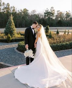 a bride and groom posing for a wedding photo