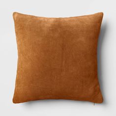 a brown suede pillow on a white background