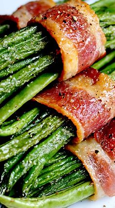 bacon wrapped asparagus on a white plate