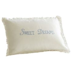 a white pillow with blue lettering on it that says, sweet dreams and the words