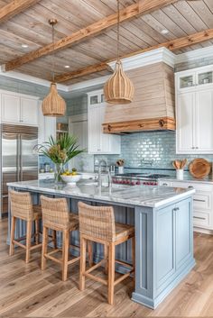 a large kitchen with an island in the middle and chairs at the counter top on both sides