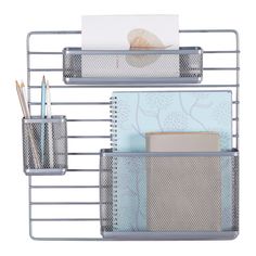 two metal shelves holding pens, notebooks and other office supplies