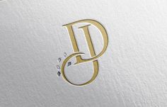 the letter d is made up of gold and silver foil with diamonds on it's edges