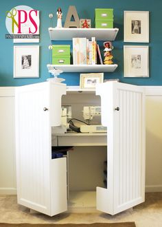 an open closet in the corner of a room with pictures on the wall and bookshelves