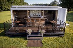 an outdoor dining area on the back of a mobile home