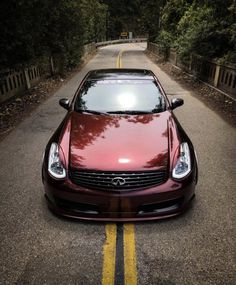 a red car parked on the side of a road