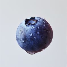 a blueberry in the air with water droplets on it